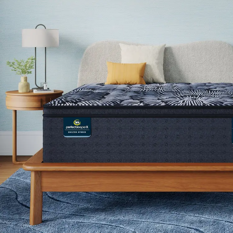 Perfect Sleeper X Quilted Hybrid Lexton Pillow Top Mattress sitting in a brown bedframe || feel: Medium Pillow Top || level: Level 1