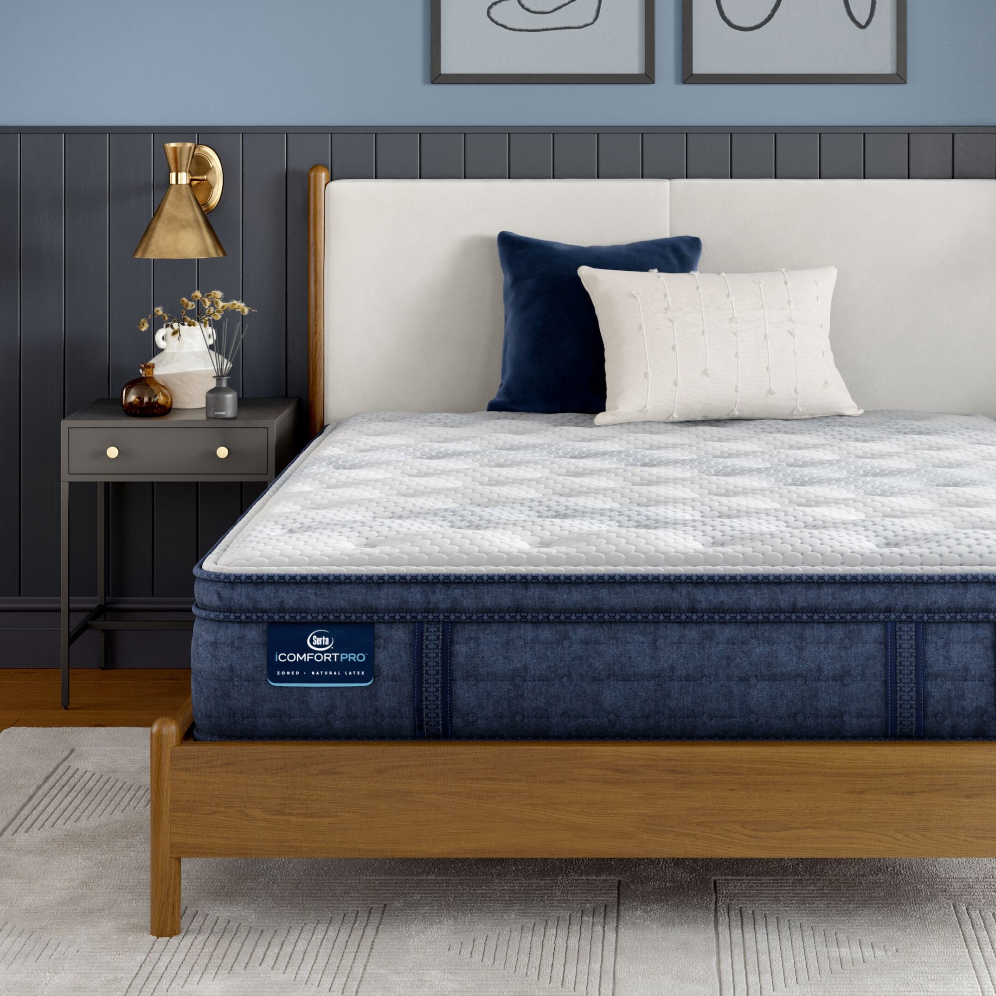iComfortPro Dartmouth Pillow Top Mattress sitting in a brown bedframe || feel: plush pillow top || level: Level 2